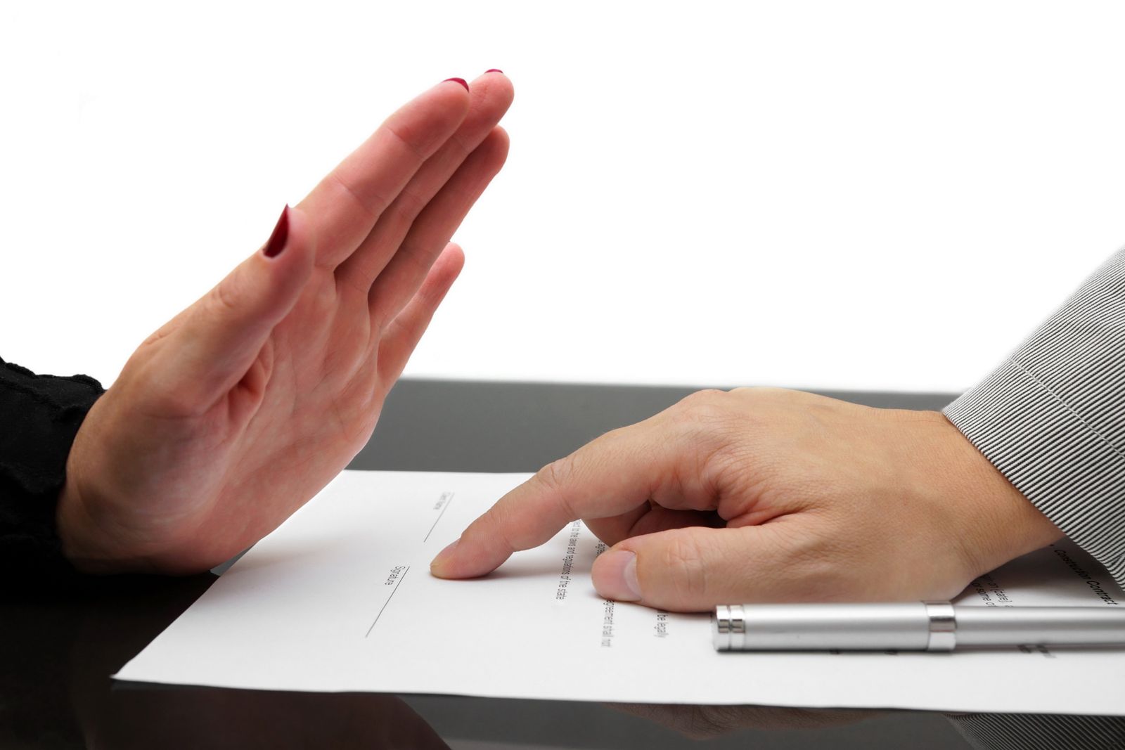 Hand gesturing to reject a contract with a pen on a document